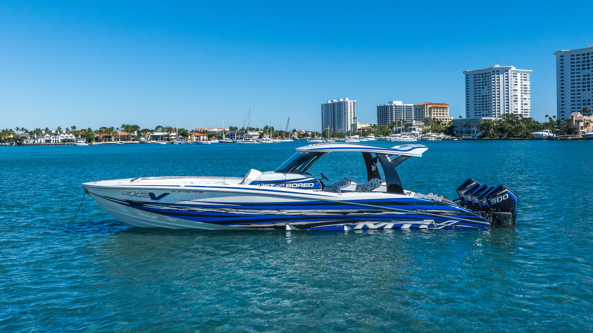 Aerial drone pursuit shot — performance boat at full speed